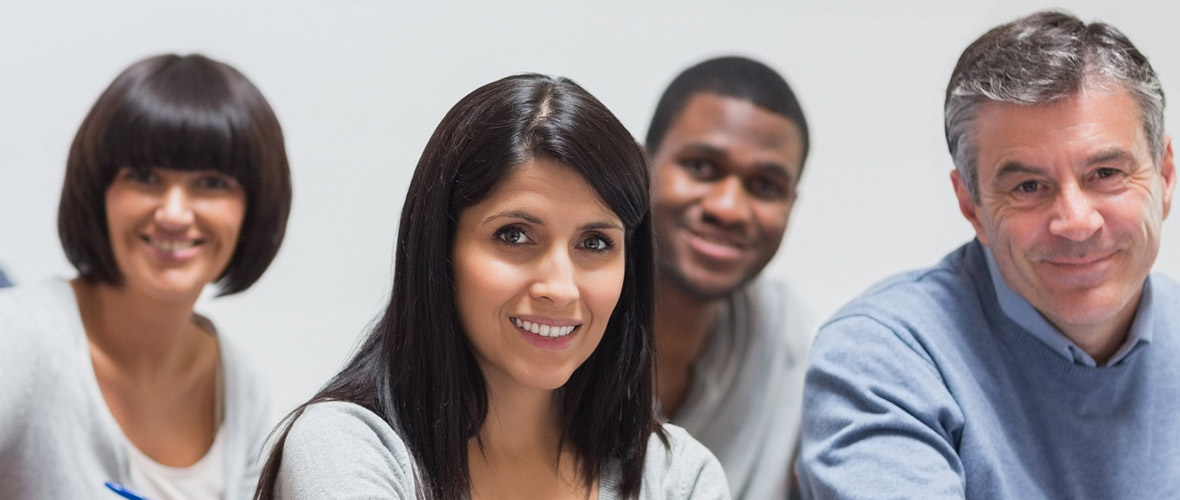 Image of four smiling adult learners facing the camera.