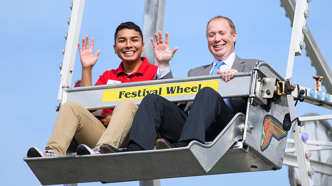 SGA President Ulysses Herrera and Acting President Don Killingsworth ride the ferris wheel together at the Homecoming Carnival