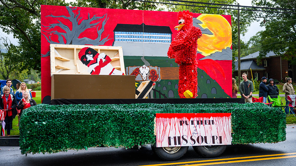 A float in the JSU Homecoming Parade  features Cocky and a SEMO Redhawk