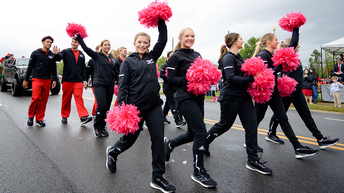 JSU cheerleaders, carrying pink pompoms for breast cancer awareness, walk in the parade