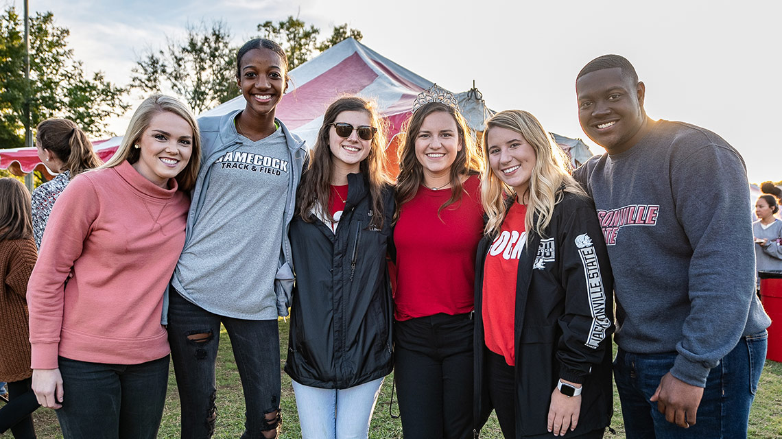 Members of the Homecoming Court embrace at the Shrimp Boil