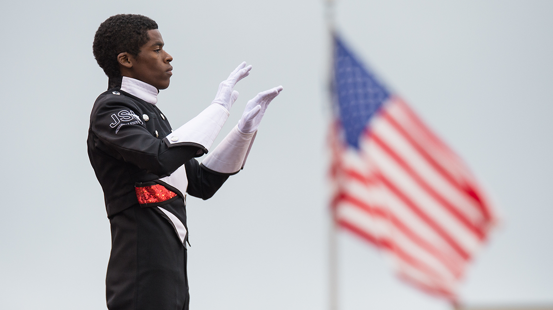 Drum Major with flag in background
