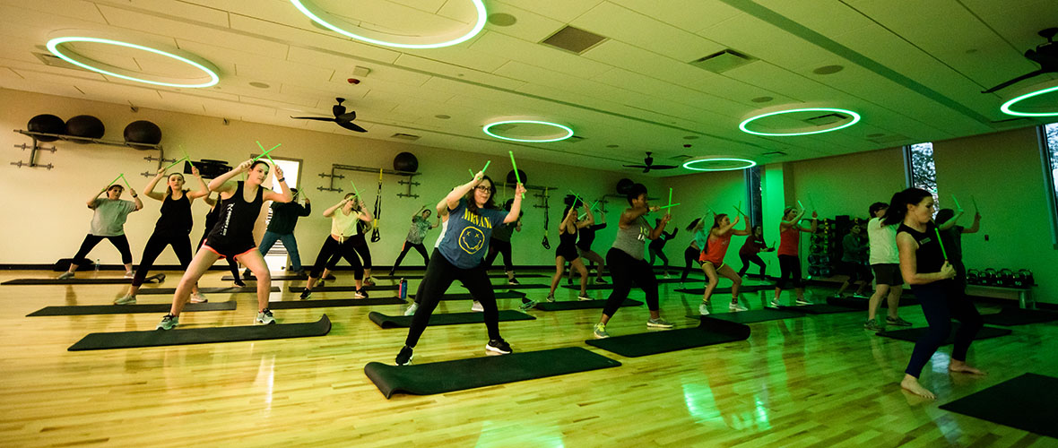 Participants rock out during a Pound fitness class