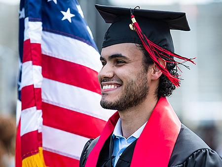 Student in front of US Flag