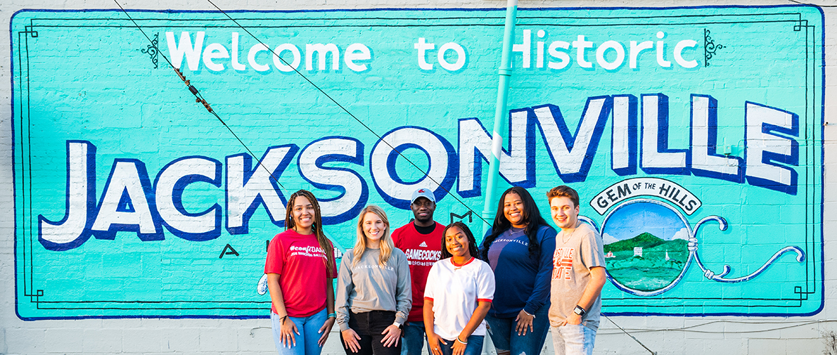 Students in front of the Jacksonville sign