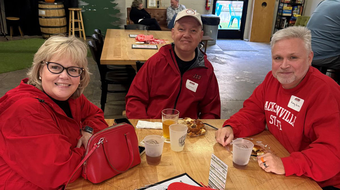 alumni sit at a table together