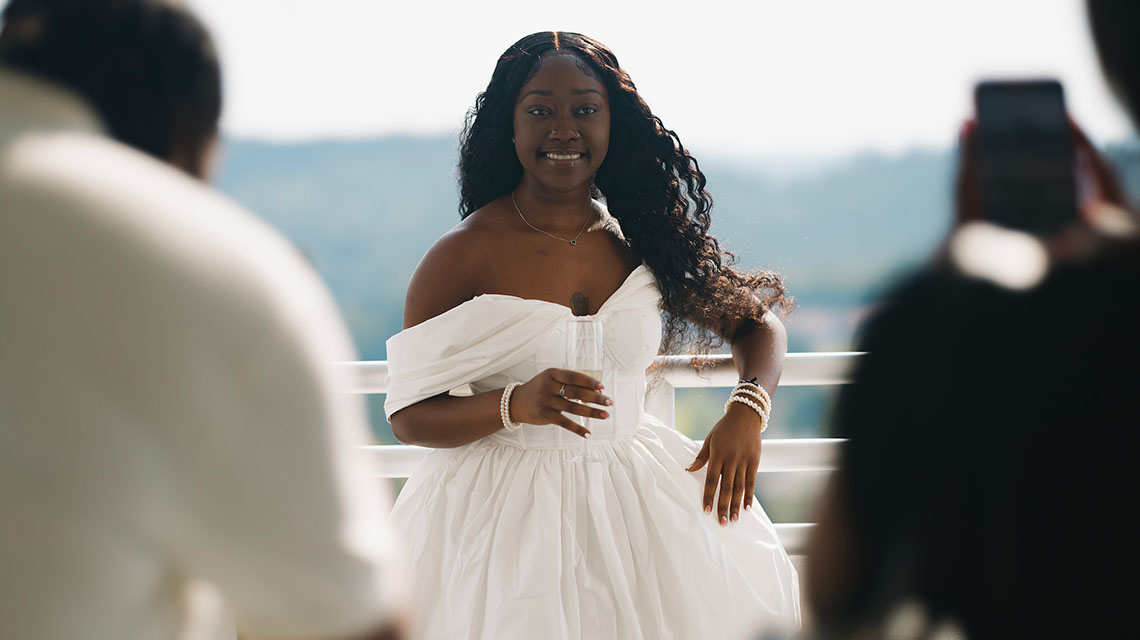 A student posing with her glass