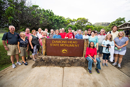 Alumni at the Diamond Head sign in Hawaii