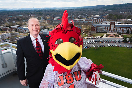 President Killingsworth and Cocky on the observation deck of the Houston Cole Library, with the campus behind them