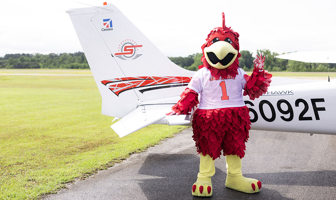 Cocky next to plane