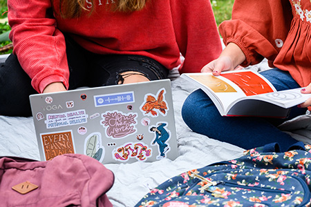 closeup of motivational quote stickers on a laptop 