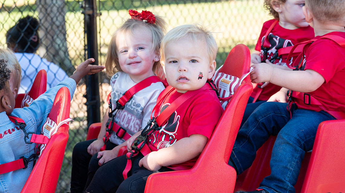Little ones on the red buggy on the playground