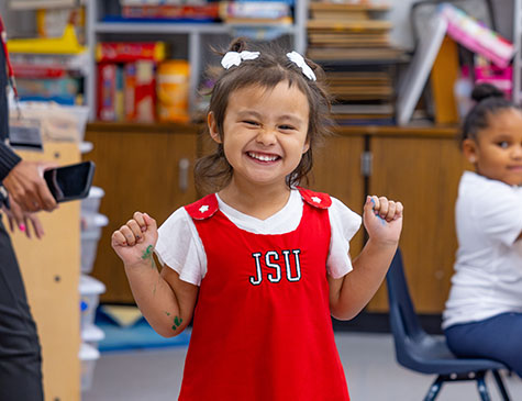 A youngster in a JSU dress at the Child Development Center.