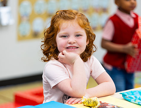 Young student at a table at the Child Development Center