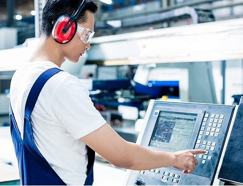 Worker operating a CNC machine