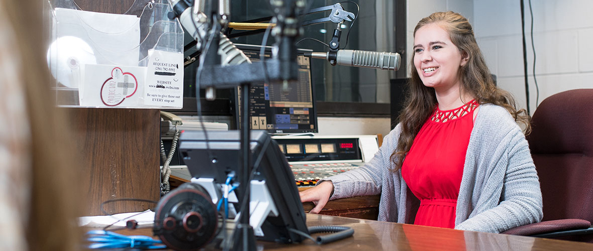 Student in WLJS broadcasting room