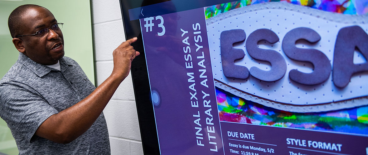 Rodney Bailey points to screen while teaching