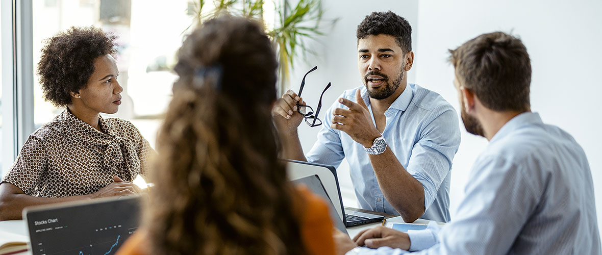 Employees working around conference table