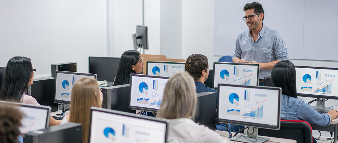 A teacher with her students in the computer lab