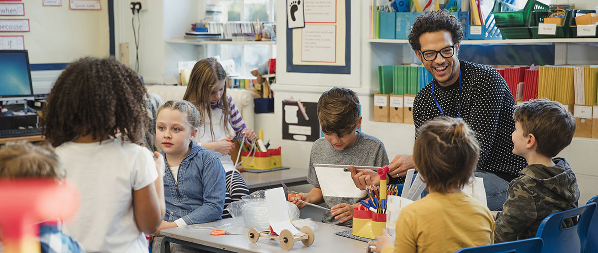 Young students sitting while listening to teacher