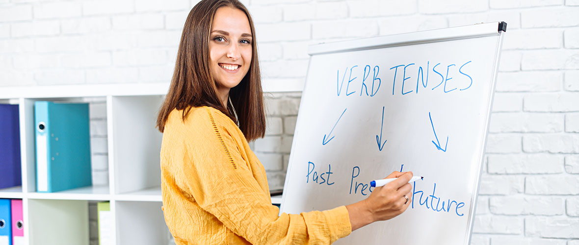 English Teacher in front of whiteboard