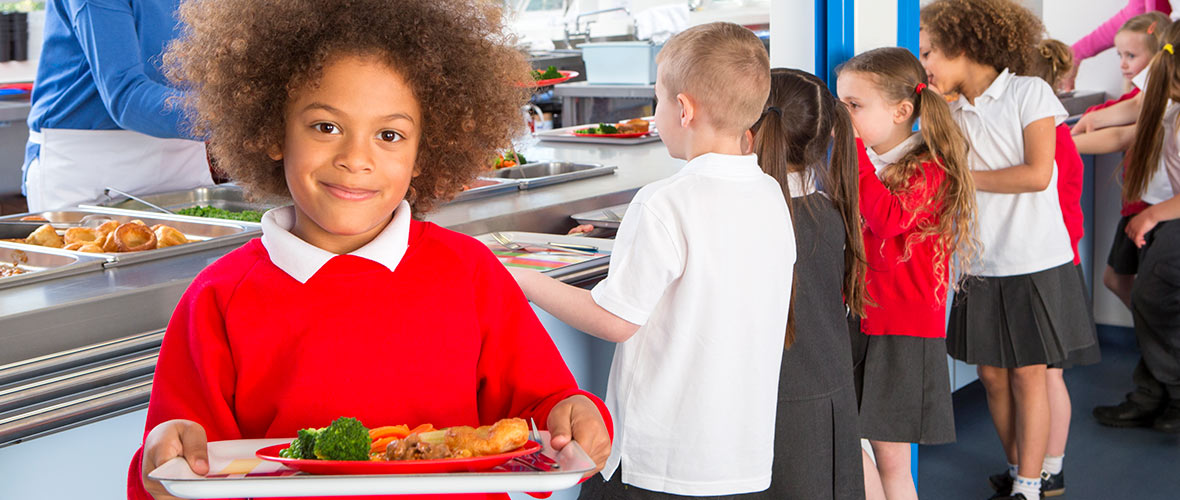 A young female student displays her healthy lunch tray