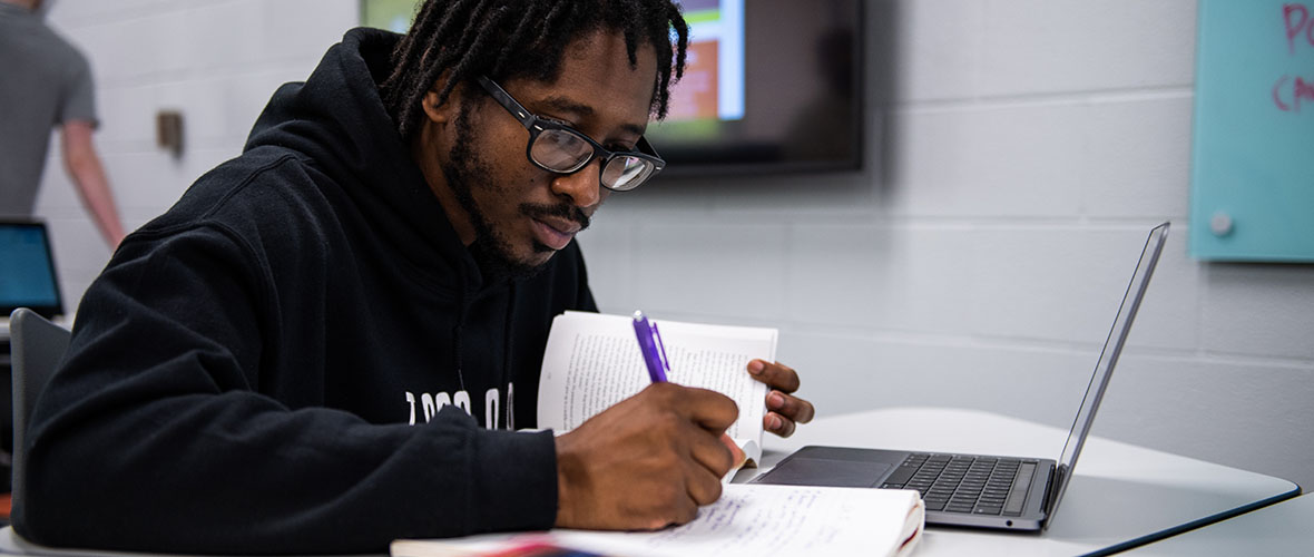 Student writing in notebook