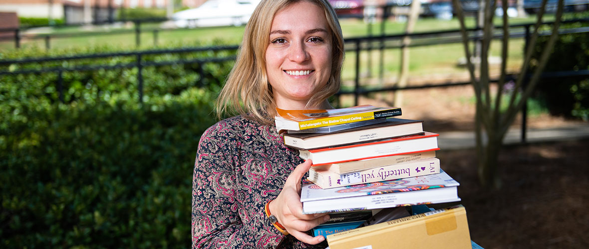 Student holding literature books