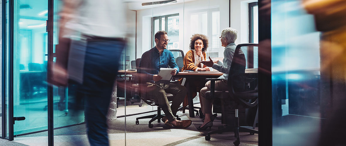 Employees working around conference table