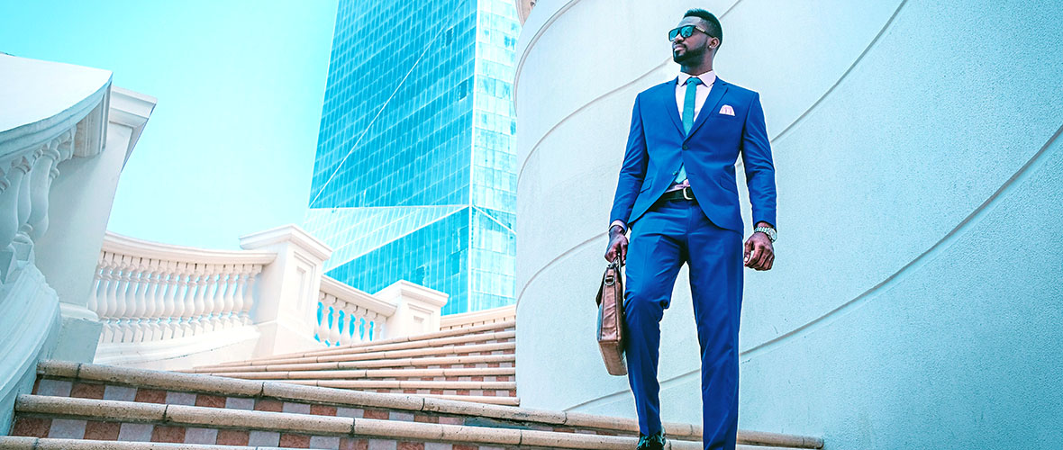 Professional entrepreneur in blue suit on stairs