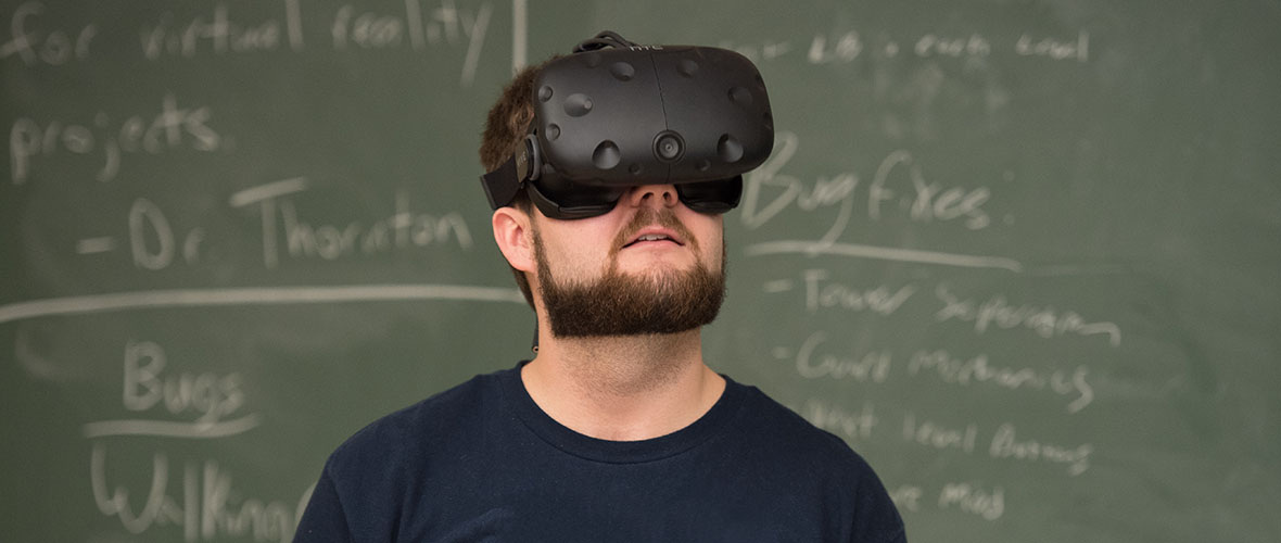 Student using a VR headset in game design