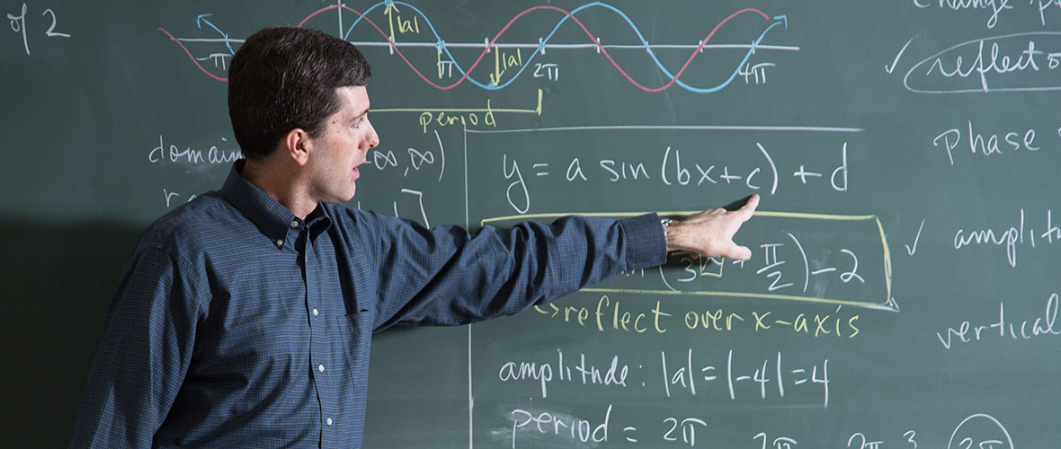 Math professor standing at a chalkboard