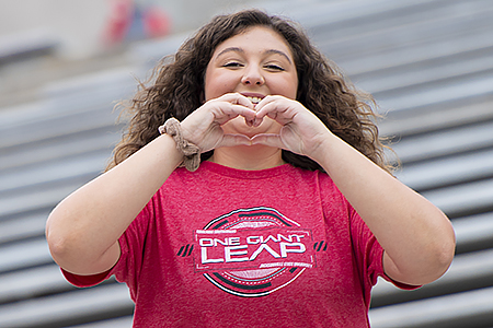 Student making heart sign with hands