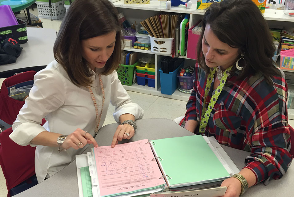 Cooperating Teacher and student reviewing documents