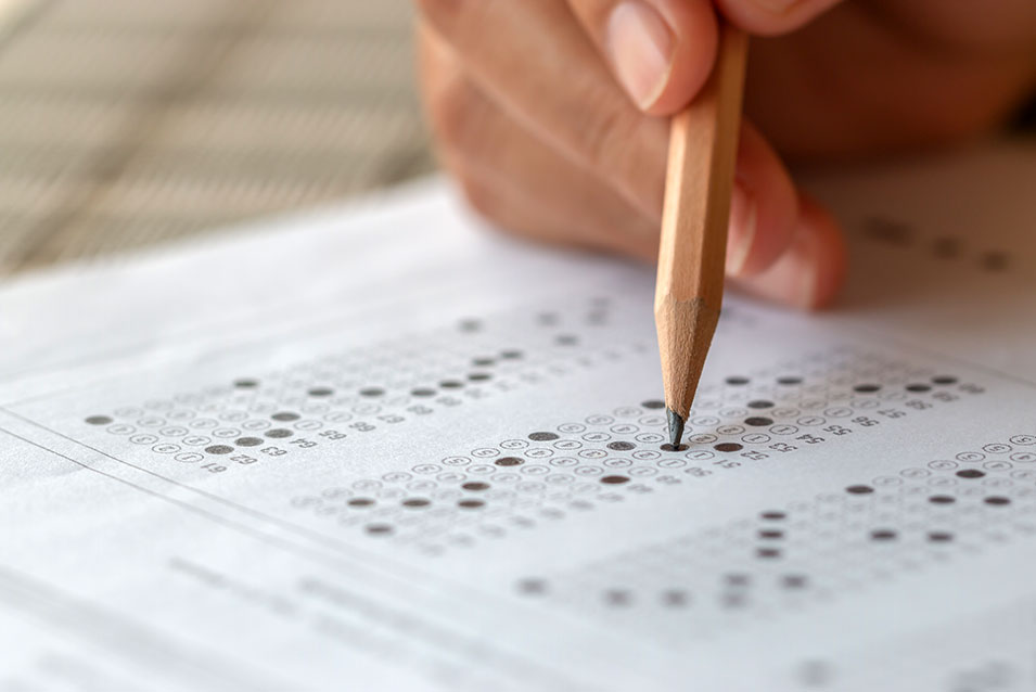 Someone fills in bubbles on a scantron