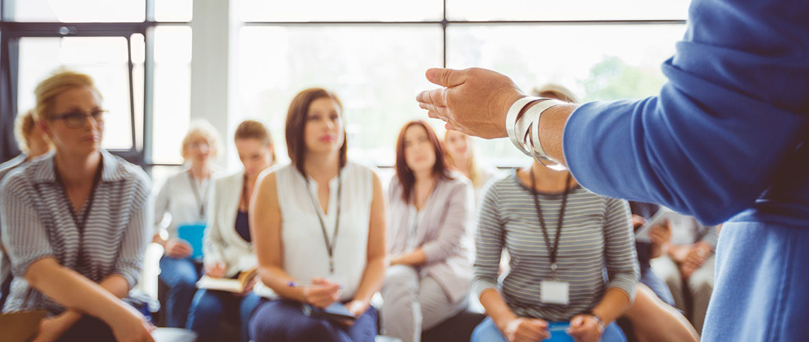 a teacher in front of a group of her colleagues