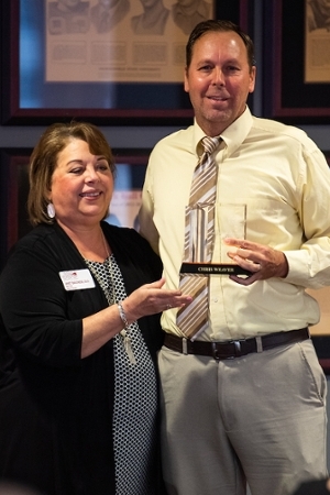 Dr. Kory Hill accepting award for Mr. Chris Weaver