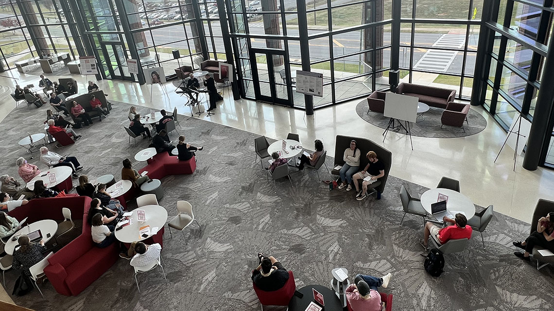 Attendees in the atrium of Merrill Hall