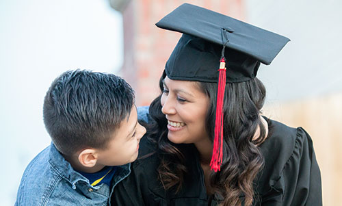 A graduate and her child celebrate on graduation day