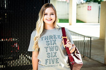 A student at JSU Stadium walking to class