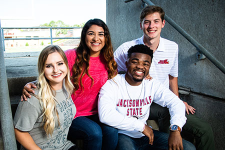 four students hanging out at JSU Stadium