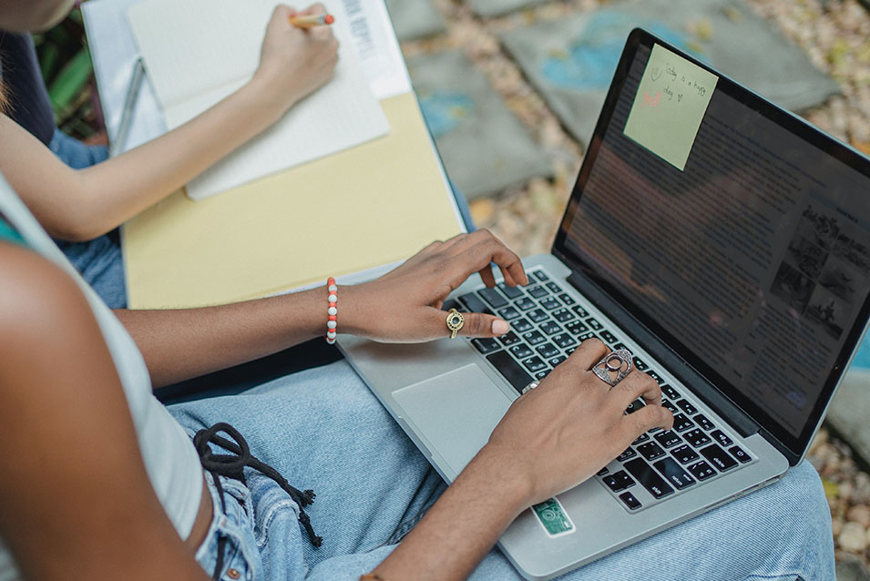 Student completing online form on laptop