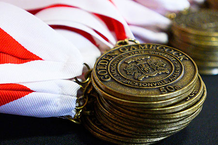 the golden gamecocks medallions lie on a table