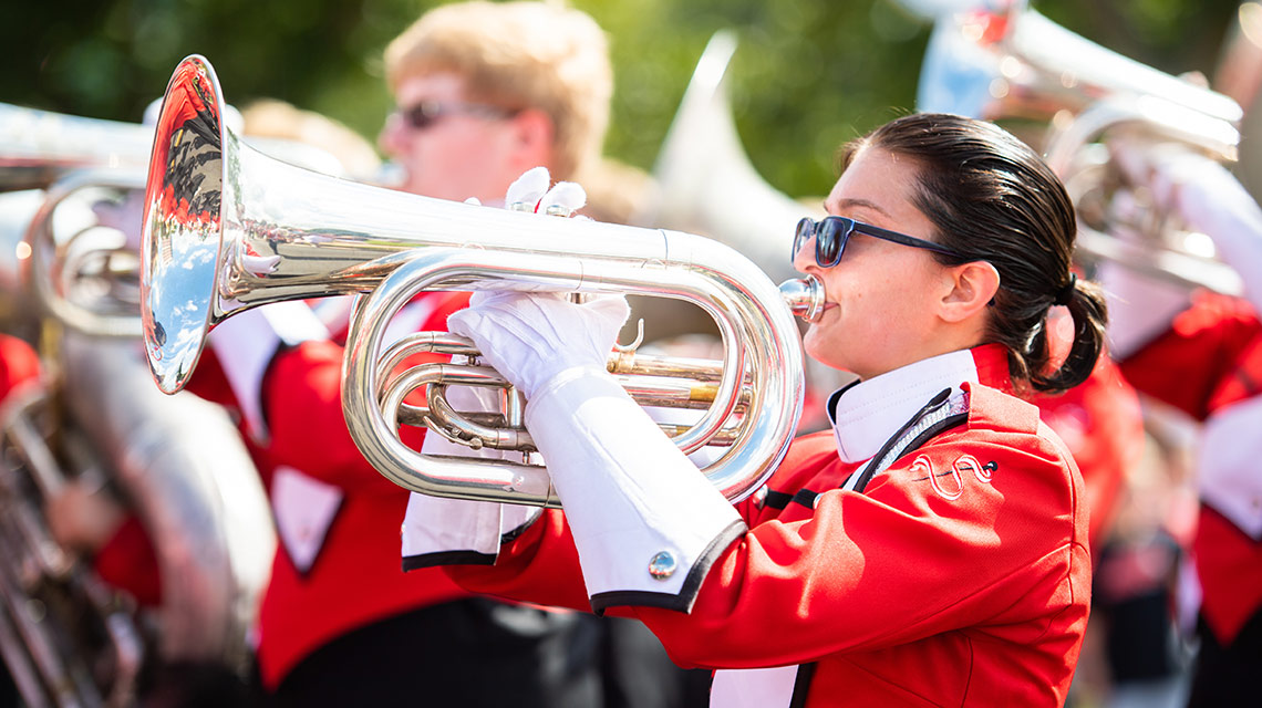 brass player in the homecoming parade