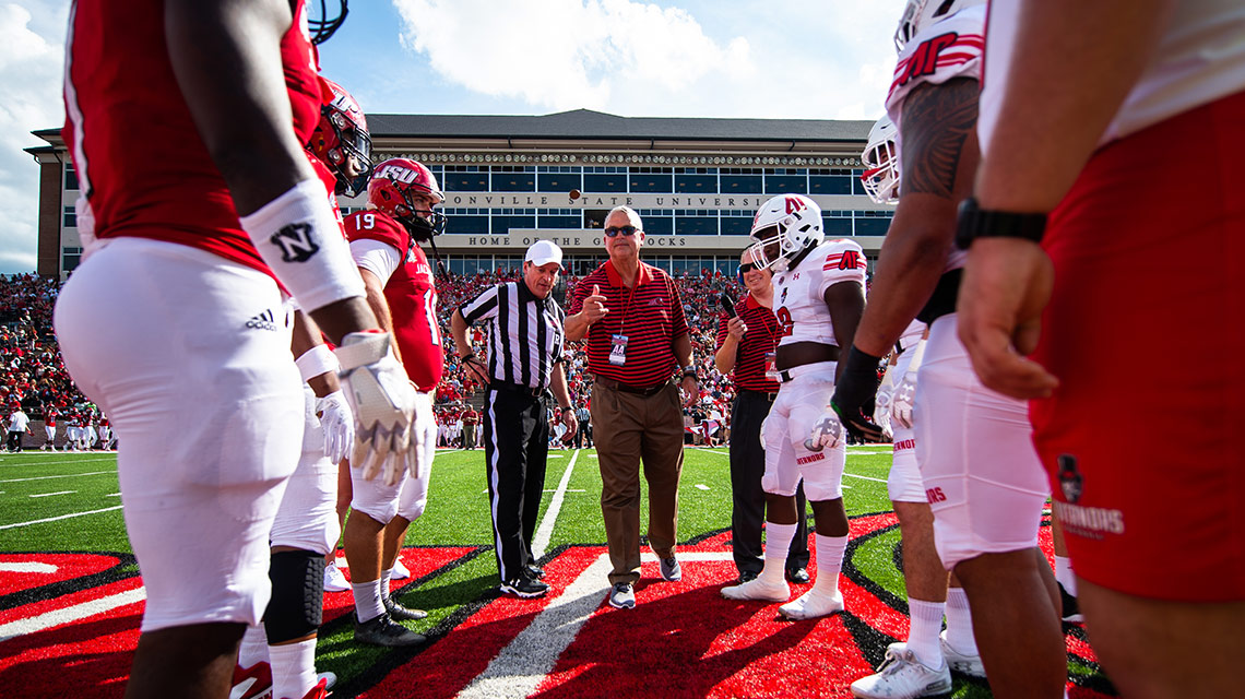 JSU baseball coach Jim Case flips the coin to start the homecoming game