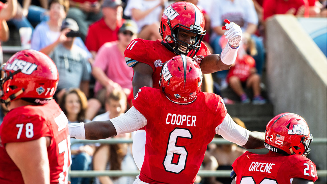Quarterback Zerrick Cooper and Josh Pearson celebrate a score during the homecoming game