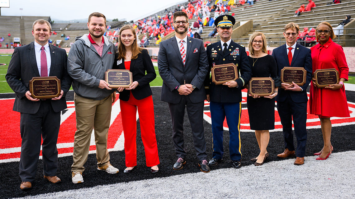 The Alumni of the Year on the field during halftime festivities
