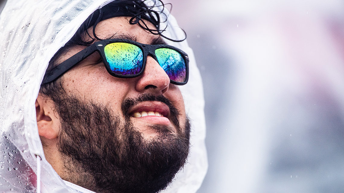 Raindrops reflected in the sunglasses of a ponchoed Marching Southerner
