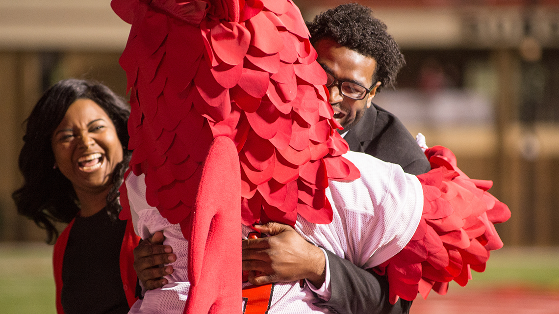 Cocky hugging homecoming king