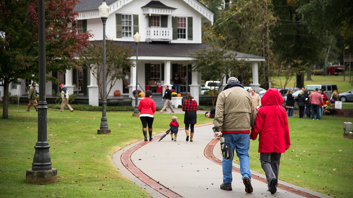 Alumni walking on Alumni House path